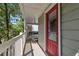 Covered front porch featuring a red front door and white railing at 2002 Shalimar Ne Dr, Chamblee, GA 30345