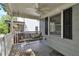 Cozy covered porch with ceiling fan and a charming porch swing at 2002 Shalimar Ne Dr, Chamblee, GA 30345