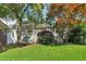 Charming home with a covered front porch and a beautifully landscaped front yard and vibrant foliage at 2002 Shalimar Ne Dr, Chamblee, GA 30345