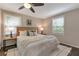 Cozy main bedroom with hardwood floors, fan, two windows, and a comfortable king bed at 2002 Shalimar Ne Dr, Chamblee, GA 30345