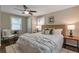 Comfortable main bedroom with hardwood floors, ceiling fan, two windows, and king bed at 2002 Shalimar Ne Dr, Chamblee, GA 30345