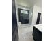 Modern bathroom featuring a glass-enclosed shower with herringbone tiling and a tiled floor at 2588 Abner Nw Pl, Atlanta, GA 30318