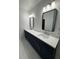Modern bathroom with double sinks, vanity, and modern lighting fixtures at 2588 Abner Nw Pl, Atlanta, GA 30318