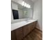 Bathroom vanity with a long countertop, cabinets, and a large mirror at 2588 Abner Nw Pl, Atlanta, GA 30318