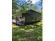 Well-maintained home exterior showcasing its modern design, covered patio, and lush green yard at 2588 Abner Nw Pl, Atlanta, GA 30318