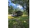 Well-maintained home exterior showcasing its modern design, covered patio, and lush green yard at 2588 Abner Nw Pl, Atlanta, GA 30318