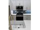 Close up of a kitchen with stainless steel appliances, a white countertop, and white cabinets at 2588 Abner Nw Pl, Atlanta, GA 30318