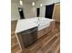 Bright kitchen island with a farmhouse sink, stainless steel dishwasher, and hardwood floors at 2588 Abner Nw Pl, Atlanta, GA 30318
