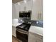 Modern kitchen features stainless steel appliances, gray cabinets, and subway tile backsplash at 2588 Abner Nw Pl, Atlanta, GA 30318