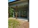 Covered patio with stained wood posts and sliding doors offers a seamless indoor-outdoor living experience at 2588 Abner Nw Pl, Atlanta, GA 30318