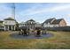 Relaxing community fire pit area with Adirondack chairs and inviting landscape at 50 Black Gum Lot 49 Ln, Auburn, GA 30011