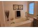 Bright bathroom showcases a deep soaking tub with tile surround and decorative accents at 522 Blue Mountain, Canton, GA 30114