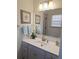 Bathroom vanity featuring a bright mirror, framed art, and modern fixtures at 522 Blue Mountain, Canton, GA 30114