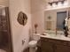 Stylish bathroom features a toilet, vanity, glass bowl sink and shower at 522 Blue Mountain, Canton, GA 30114