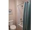 Bathroom with white tiled shower/tub combo and a decorative butterfly picture at 522 Blue Mountain, Canton, GA 30114