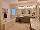 Luxurious bathroom featuring dual sinks, a soaking tub, and updated lighting at 522 Blue Mountain, Canton, GA 30114