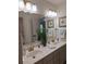 Bathroom featuring double sinks, gold fixtures, and decorative seashell art at 522 Blue Mountain, Canton, GA 30114