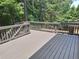 Outdoor deck with well-maintained railings and a lush, green wooded backdrop at 522 Blue Mountain, Canton, GA 30114