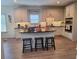 Beautiful kitchen with white cabinets, granite countertops and a center island with bar stool seating at 522 Blue Mountain, Canton, GA 30114