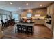 Spacious kitchen and dining area features granite counters, center island, bar stool seating, and stainless appliances at 522 Blue Mountain, Canton, GA 30114