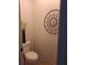 Neat powder room features decorative wall art and neutral color paint at 522 Blue Mountain, Canton, GA 30114