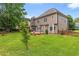 Expansive backyard with lush green grass, mature trees, and a charming patio area perfect for entertaining at 1219 Hadaway Ct, Lawrenceville, GA 30043