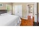 Comfortable bedroom featuring hardwood floors, a double-door closet, and natural light from the window at 1219 Hadaway Ct, Lawrenceville, GA 30043