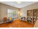 Bedroom with a large window, chair, bookcase, and wood floors at 1219 Hadaway Ct, Lawrenceville, GA 30043