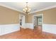 Dining room with a chandelier, wood floors, and white wainscoting at 1219 Hadaway Ct, Lawrenceville, GA 30043