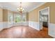 Bright dining room featuring a bay window, chandelier, and wood floors at 1219 Hadaway Ct, Lawrenceville, GA 30043