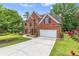Attractive brick home boasting an expansive driveway and beautifully landscaped front yard at 1219 Hadaway Ct, Lawrenceville, GA 30043