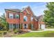 Beautiful two-story brick home with a well-manicured lawn and mature landscaping at 1219 Hadaway Ct, Lawrenceville, GA 30043