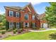 Charming brick residence showcasing manicured landscaping and a pristine, green lawn at 1219 Hadaway Ct, Lawrenceville, GA 30043