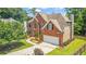 Beautiful brick house featuring an attached garage and a well-kept lawn with lovely landscaping at 1219 Hadaway Ct, Lawrenceville, GA 30043