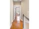 Hallway with wood floors leading to a room with natural light streaming through the window at 1219 Hadaway Ct, Lawrenceville, GA 30043