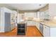 Kitchen featuring white cabinets, stainless steel appliances, granite countertops, and a center island at 1219 Hadaway Ct, Lawrenceville, GA 30043