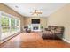Spacious living room featuring a fireplace, large windows, and comfortable seating, perfect for relaxation at 1219 Hadaway Ct, Lawrenceville, GA 30043