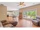 Living room featuring wood floors, a fireplace, view to the kitchen, and access to the back patio at 1219 Hadaway Ct, Lawrenceville, GA 30043