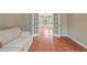 Cozy living room with wood floors and french doors to a bright windowed room at 1219 Hadaway Ct, Lawrenceville, GA 30043