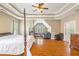 Large main bedroom featuring a four-poster bed and a cozy sitting area at 1219 Hadaway Ct, Lawrenceville, GA 30043