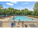 Community pool with lounge chairs and umbrellas, perfect for relaxation and recreation at 1219 Hadaway Ct, Lawrenceville, GA 30043