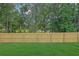 Wide view of backyard with newly installed wood fence for privacy and security at 153 Alaina Rd, Holly Springs, GA 30115