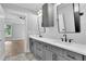 Bathroom featuring a double sink vanity with modern fixtures and view into bedroom at 153 Alaina Rd, Holly Springs, GA 30115