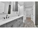 Dual sink bathroom with grey vanities and walk-in closet at 153 Alaina Rd, Holly Springs, GA 30115