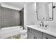 Bathroom featuring modern vanity, tile shower, and sleek fixtures at 153 Alaina Rd, Holly Springs, GA 30115