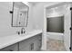 Bathroom with gray vanity, white countertop, and full tub with grey tiled walls at 153 Alaina Rd, Holly Springs, GA 30115