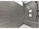Walk-in shower with gray tiled walls and built-in niche at 153 Alaina Rd, Holly Springs, GA 30115