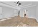 Spacious bedroom with tray ceiling, wood floors, and natural light at 153 Alaina Rd, Holly Springs, GA 30115