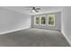 Spacious bedroom with large windows, neutral carpet, and natural light at 153 Alaina Rd, Holly Springs, GA 30115