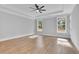 Spacious bedroom with tray ceiling, wood floors, and natural light at 153 Alaina Rd, Holly Springs, GA 30115